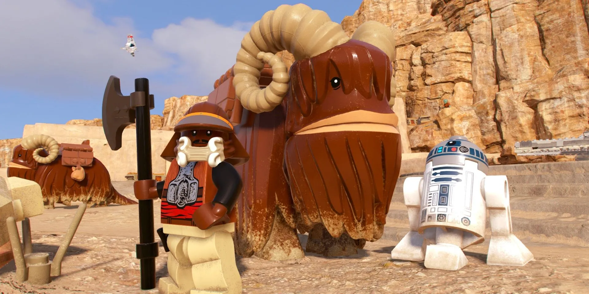 R2D2 và Lando đứng cạnh một con Bantha trong LEGO Star Wars: The Skywalker Saga