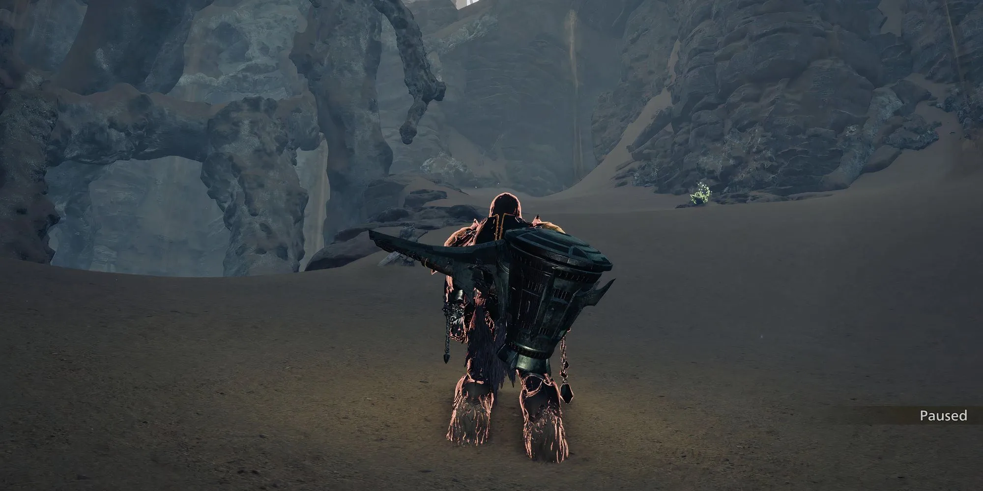 Thợ săn khám phá một hang động tối tăm để tìm Ancient Wyvern Coin trong Monster Hunter Wilds