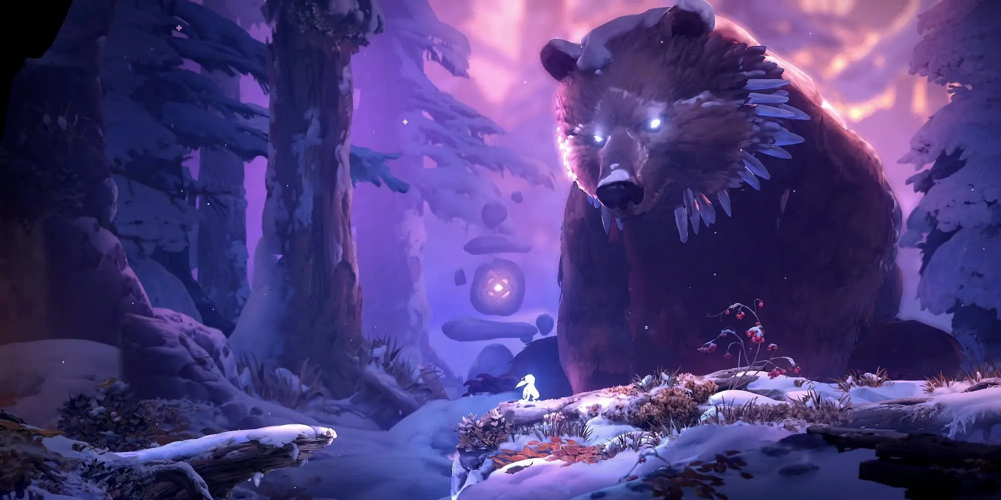Ori đứng cạnh một con gấu khổng lồ trong game Ori and the Will of the Wisps