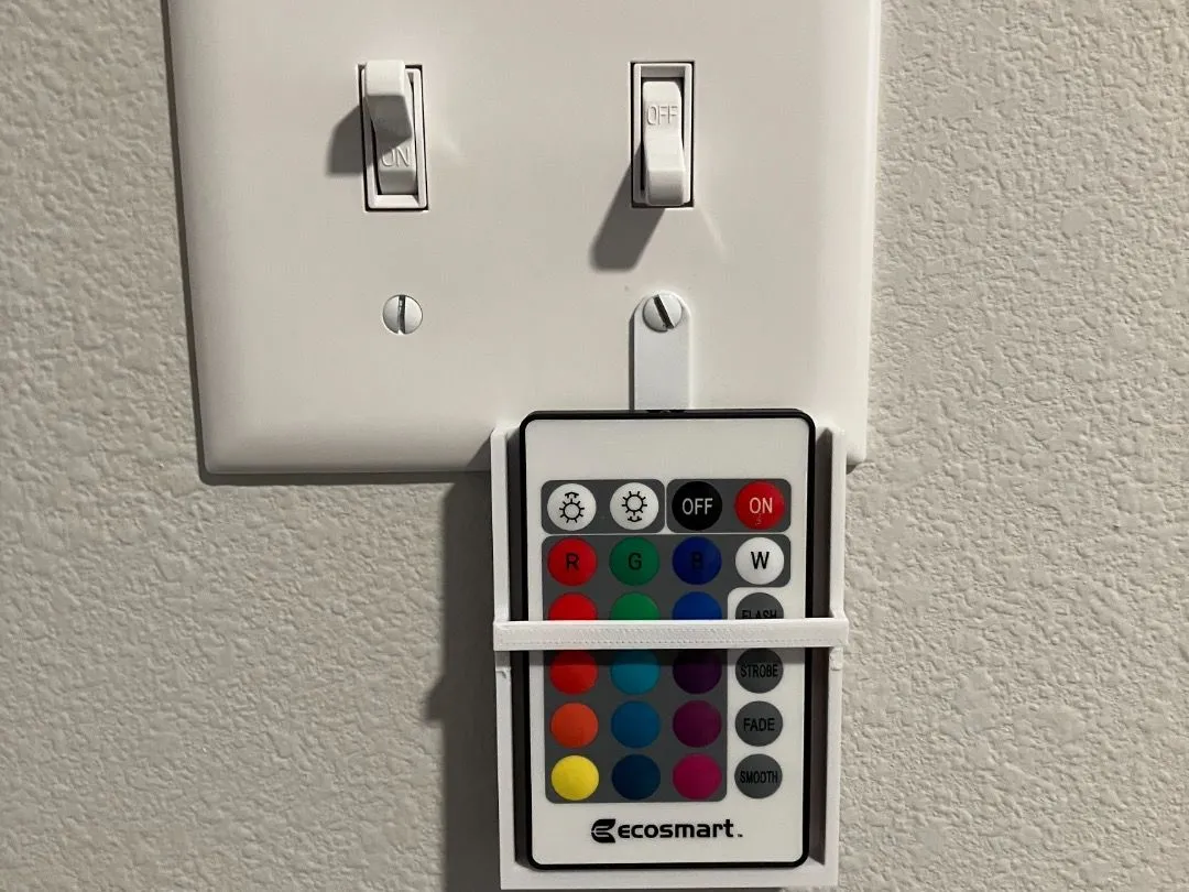 Giá đỡ remote gắn lên ốp công tắc in 3D giữ điều khiển LED